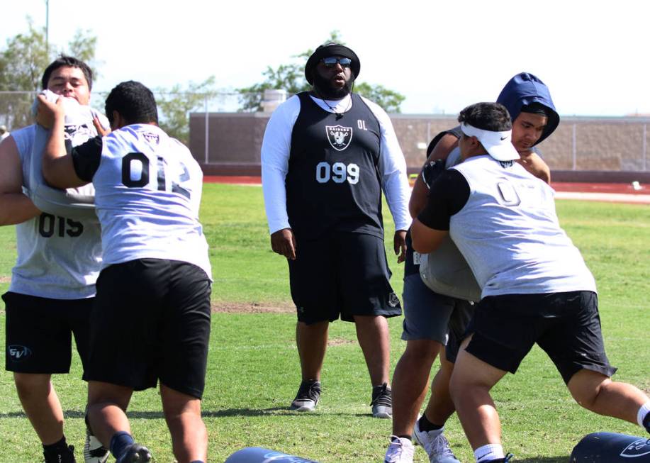 Former Faith Lutheran high school's offensive line coach De'Andre Nicholas, center, watches as ...