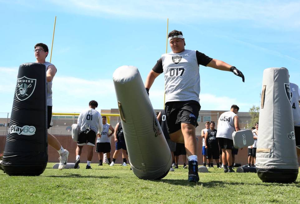 Henry Lim, right, Basic High's offensive guard, hits a bag as local Clark County area high scho ...