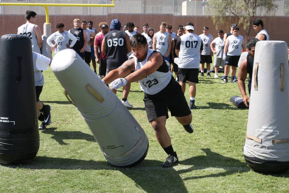 Blaze Homalon, Desert OasisHigh's defensive tackle, hits a bag as local Clark County area high ...