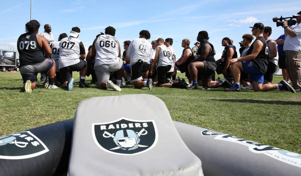 Clark County-area high school football players listen to Reggie Kinlaw, second left, a former ...