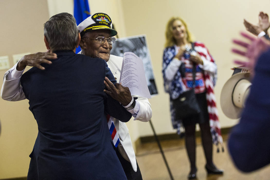 Elks Lodge official Bob Reed, left, hugs World War II, Korea and Vietnam veteran Arby Hambric, ...