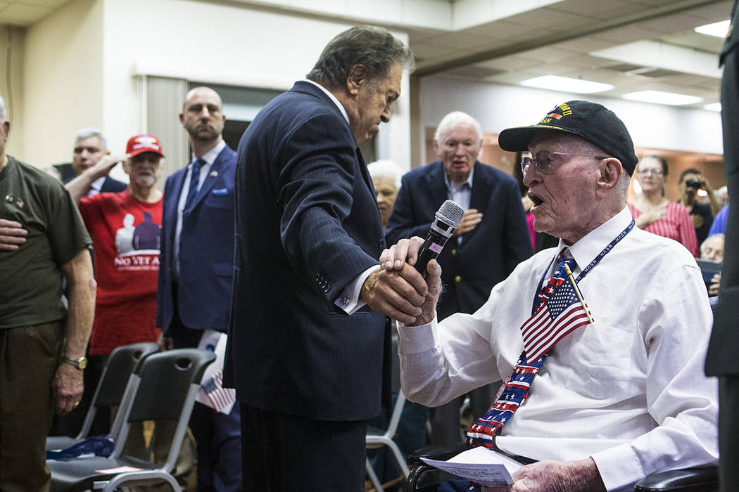 World War II veteran William Dunsmore leads the Pledge of Allegiance during a ceremony commemor ...