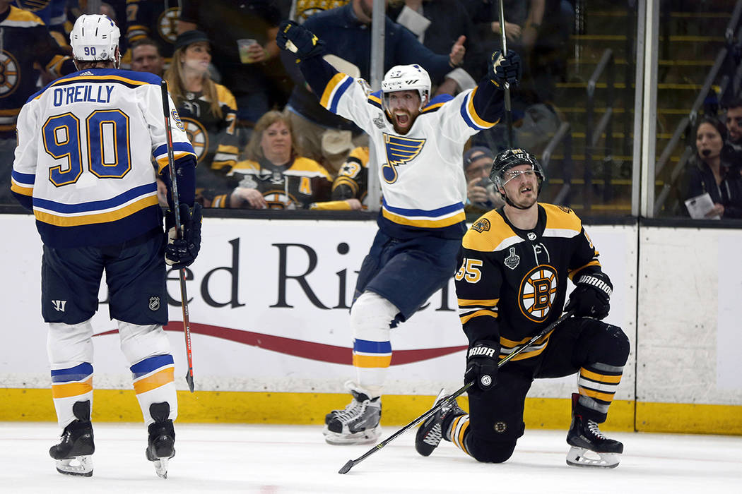 St. Louis Blues' David Perron, center, celebrates his goal behind Boston Bruins' Noel Acciari, ...