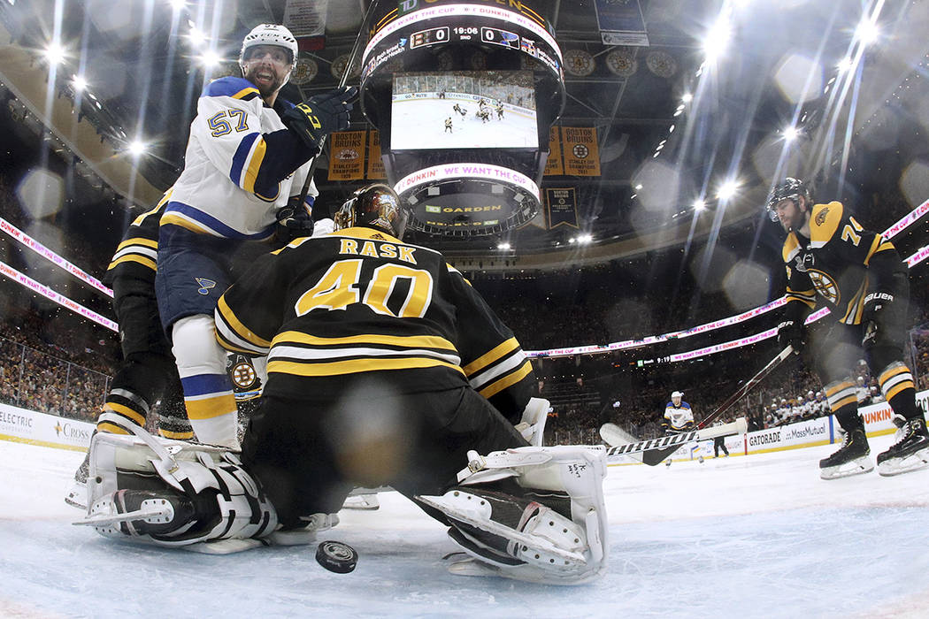 St. Louis Blues' David Perron, left, watches the puck shot by teammate Ryan O'Reilly sail throu ...