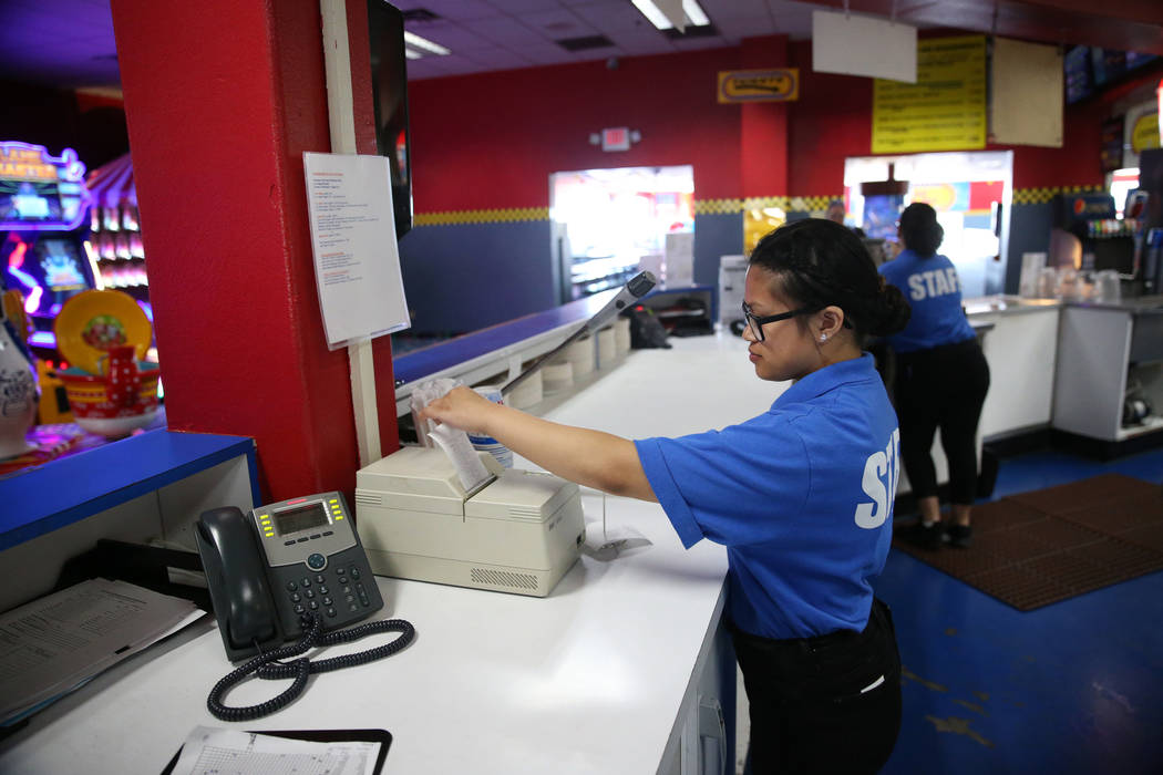 Canyon Springs High School graduate Angelica Tariman, 17, looks at a food order at the Las Vega ...