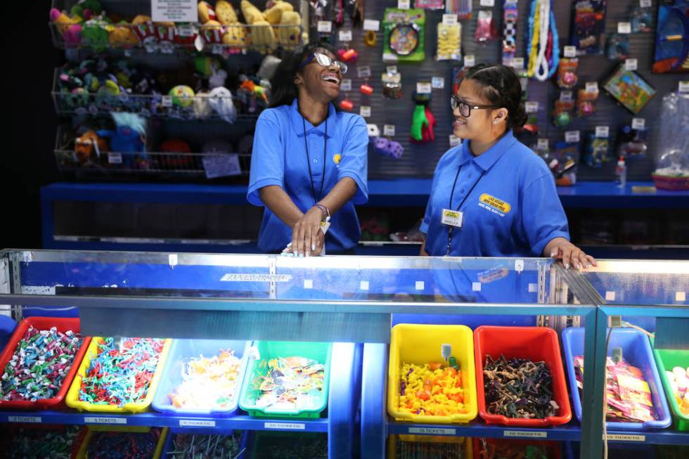 Canyon Springs High School graduate Angelica Tariman, right, 17, talks to her coworker Keiaira ...