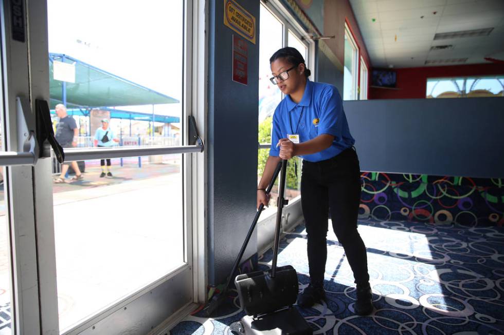 Canyon Springs High School graduate Angelica Tariman, 17, sweeps the floor at the Las Vegas Min ...