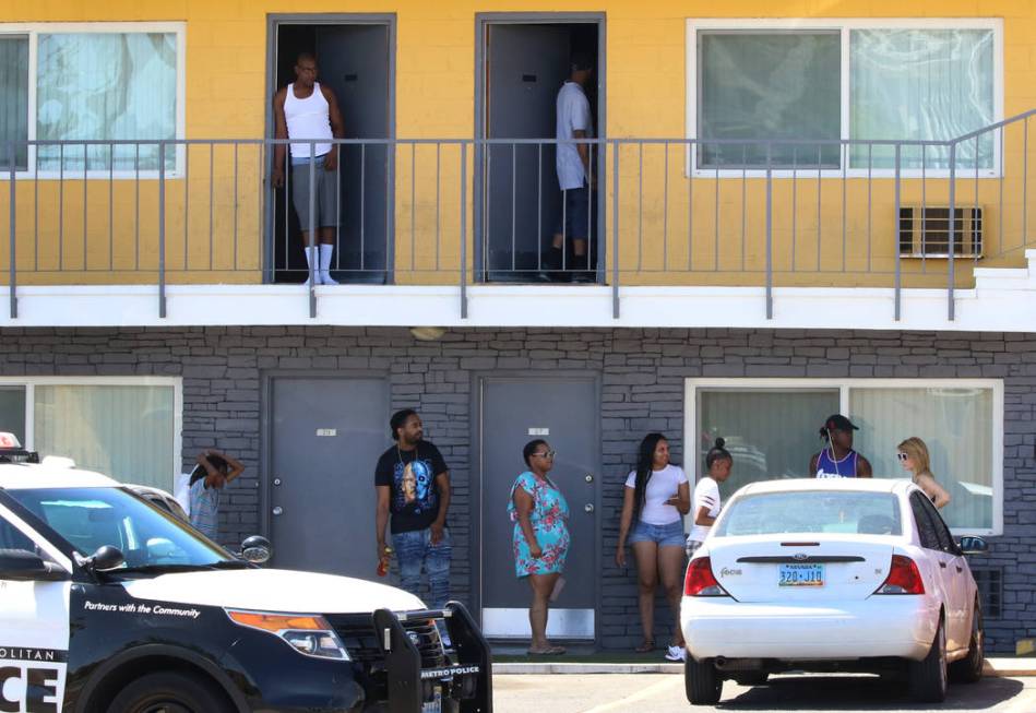 Residents at Siegel Suites watch as Las Vegas police investigate a bomb threat at 455 E. Twain ...