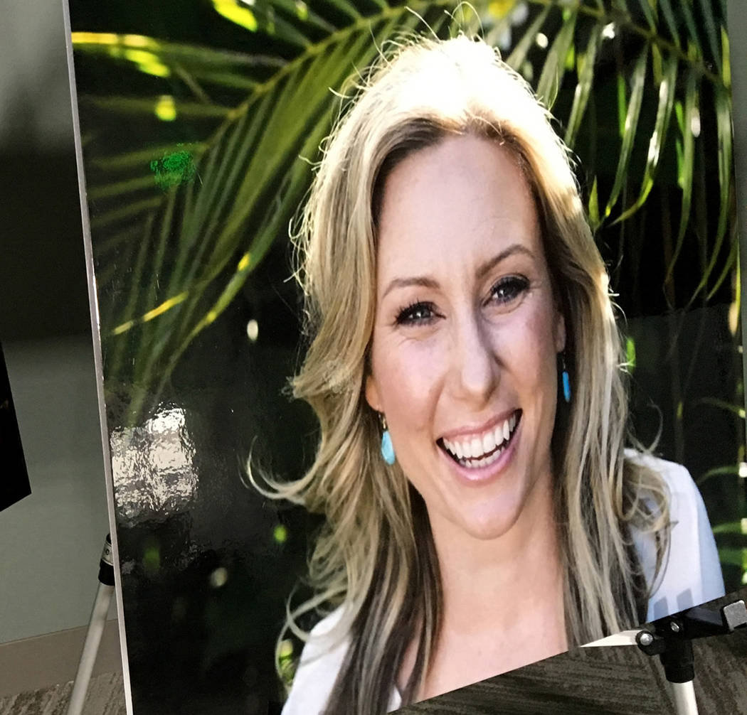 FILE - In this July 23, 2018, file photo, a poster of Justine Ruszczyk Damond is displayed at a ...