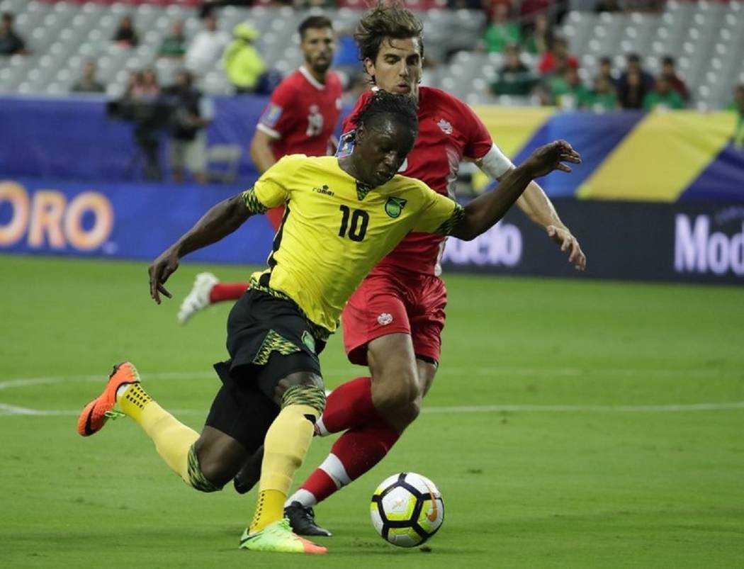 Jamaica's Darren Mattocks (10) dribbles past Canada's Dejan Jackovic during a CONCACAF Gold Cup ...