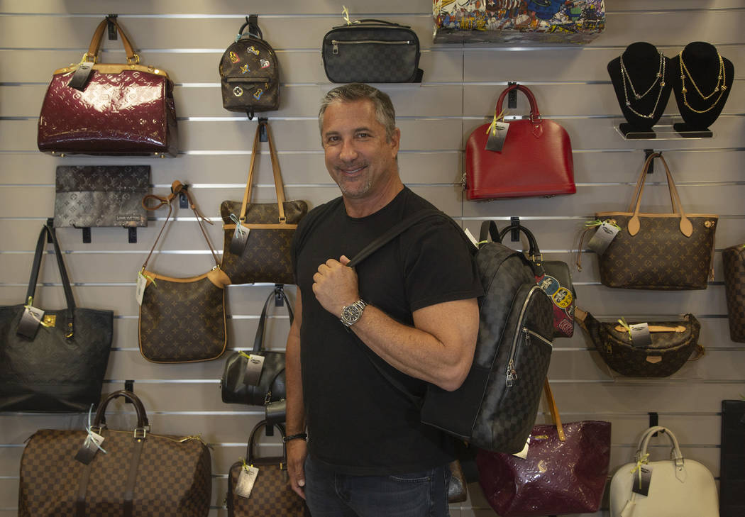 Michael Mack stands in front of luxury purses at Max Pawn in Las Vegas, Thursday, June 6, 2019. ...