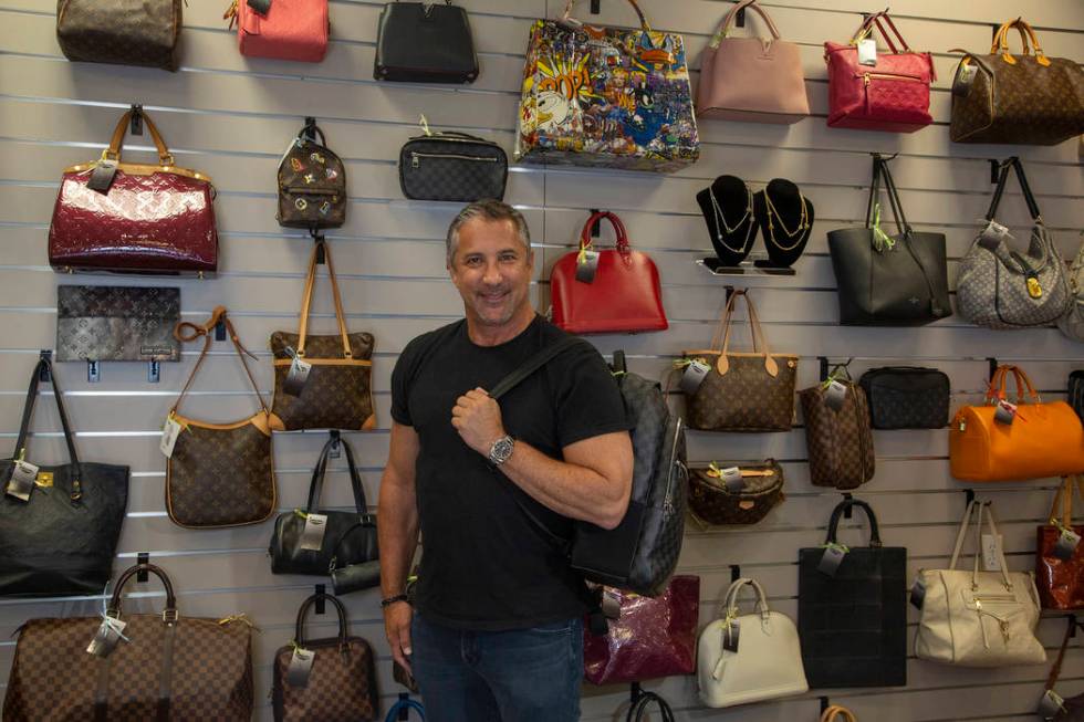 Michael Mack stands in front of luxury purses at Max Pawn in Las Vegas, Thursday, June 6, 2019. ...