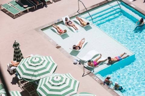 Hotel guests relax by the pool at Park MGM as temperatures reach 100 degrees in the Las Vegas V ...