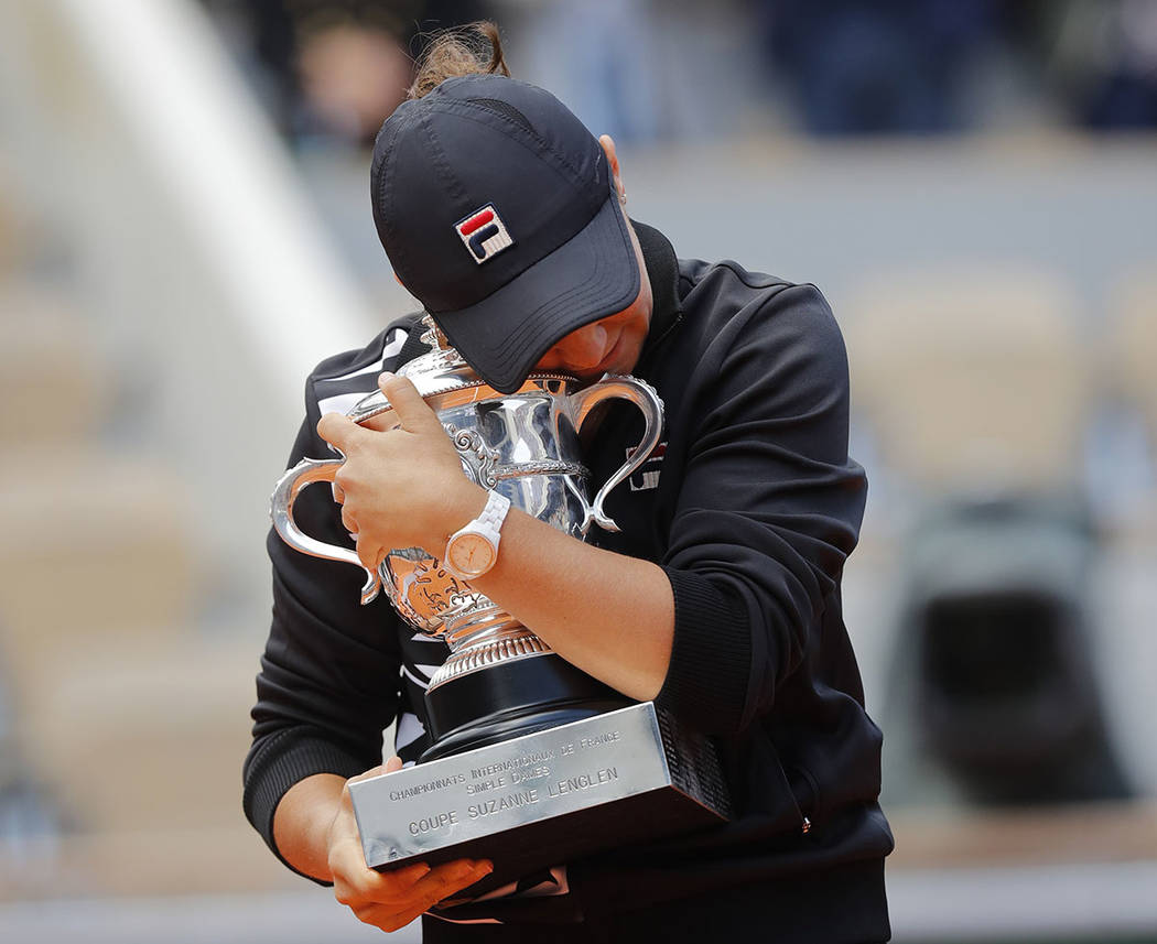 Australia's Ashleigh Barty holds the trophy as she celebrates winning her women's final match o ...