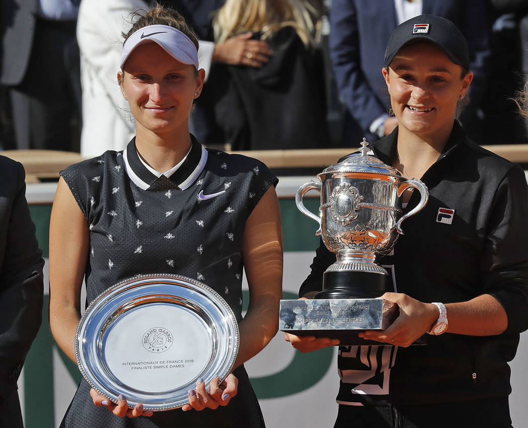 Australia's Ashleigh Barty, right, holds the trophy as she celebrates winning her women's final ...