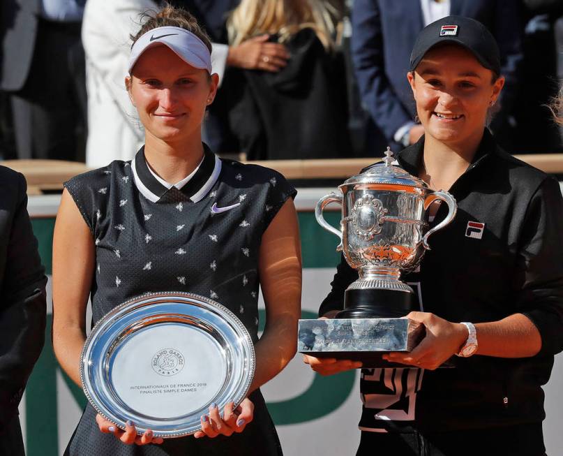 Australia's Ashleigh Barty, right, holds the trophy as she celebrates winning her women's final ...