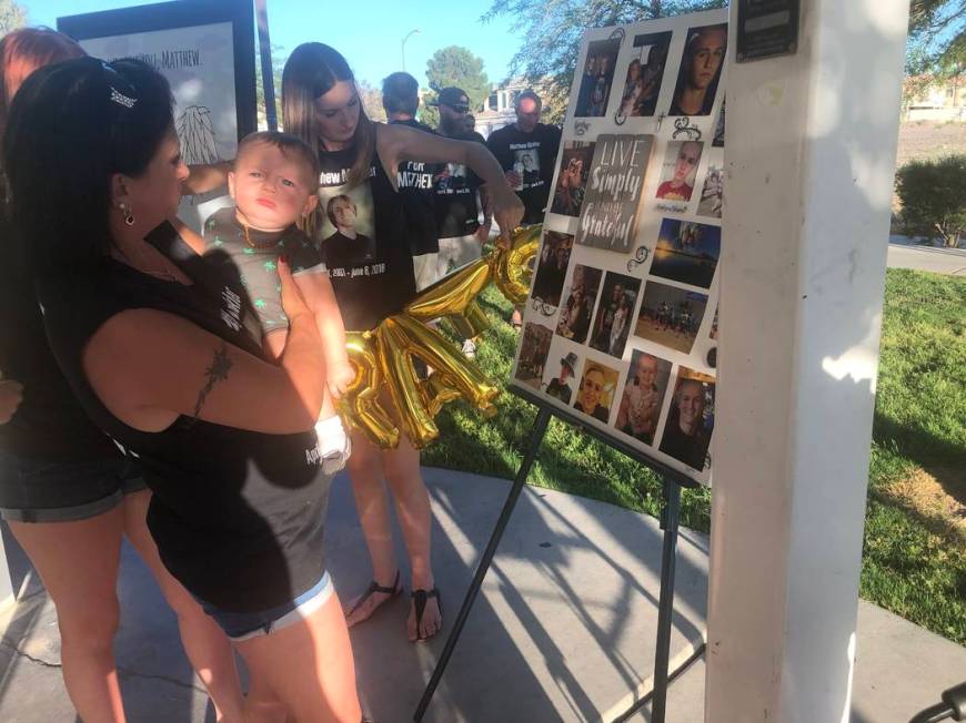 Samantha Valentine, 27, holds balloons while a family friend shows her son, 7-month-old Matthew ...