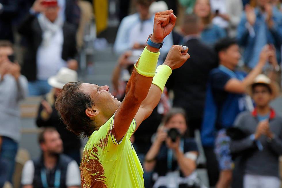 Spain's Rafael Nadal celebrates his record 12th French Open tennis tournament title after winni ...