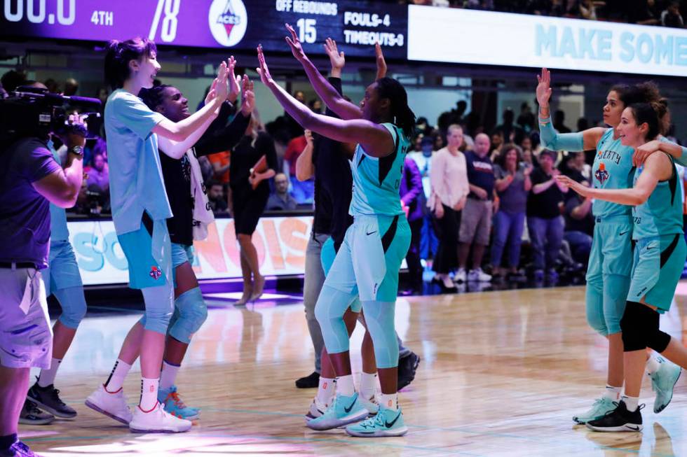 The New York Liberty celebrate after defeating the Las Vegas Aces in a WNBA basketball game, Su ...