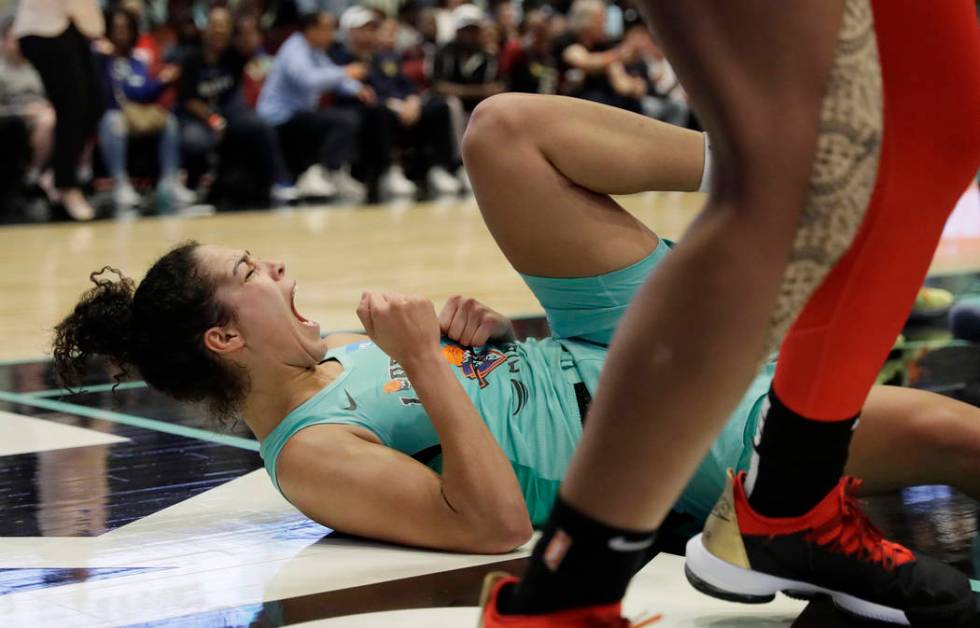 New York Liberty's Kia Nurse falls to the court after drawing an offensive foul against Las Veg ...