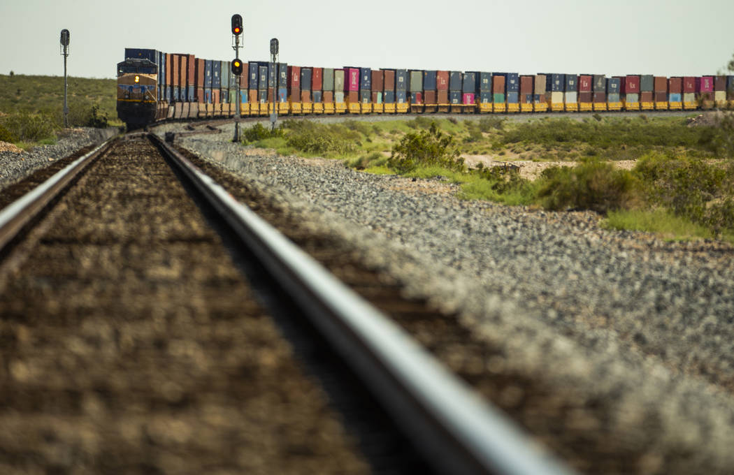A train carrying stacks of containers makes its way northbound near the Jean dry lake bed on Mo ...