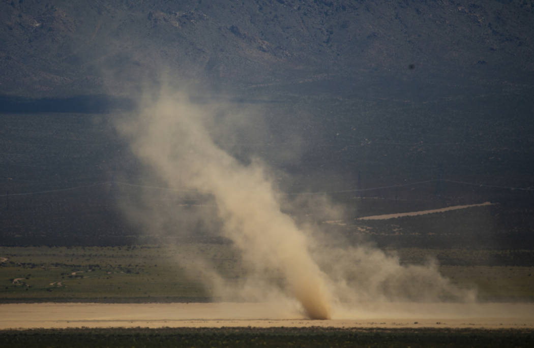 A dust devil swirls about the Jean Dry Lake bed as winds are still steady in the desert there o ...