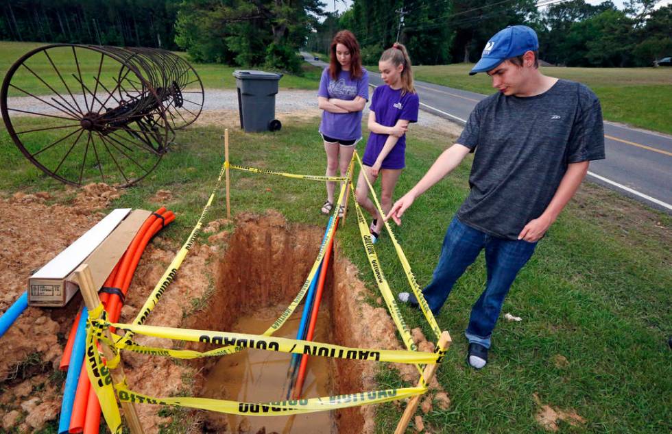 In this May 8, 2019, photograph, Riley Shaw, right, and his youngest sister, Leah, center, and ...