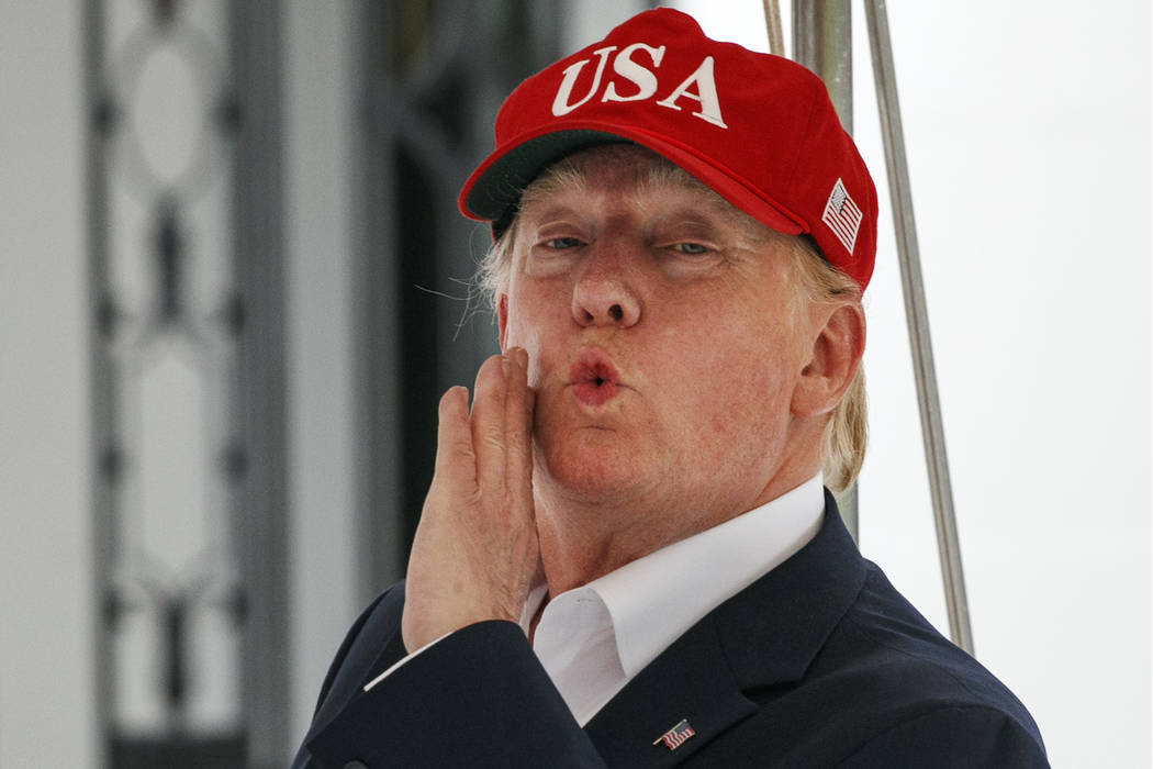 President Donald Trump responds to a question from the media as he walks into the White House, ...