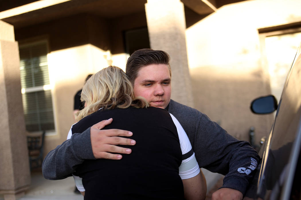 Meredith Tracy embraces her son Colin Tracy, 17, at their home in Las Vegas, Friday, Nov. 2, 20 ...