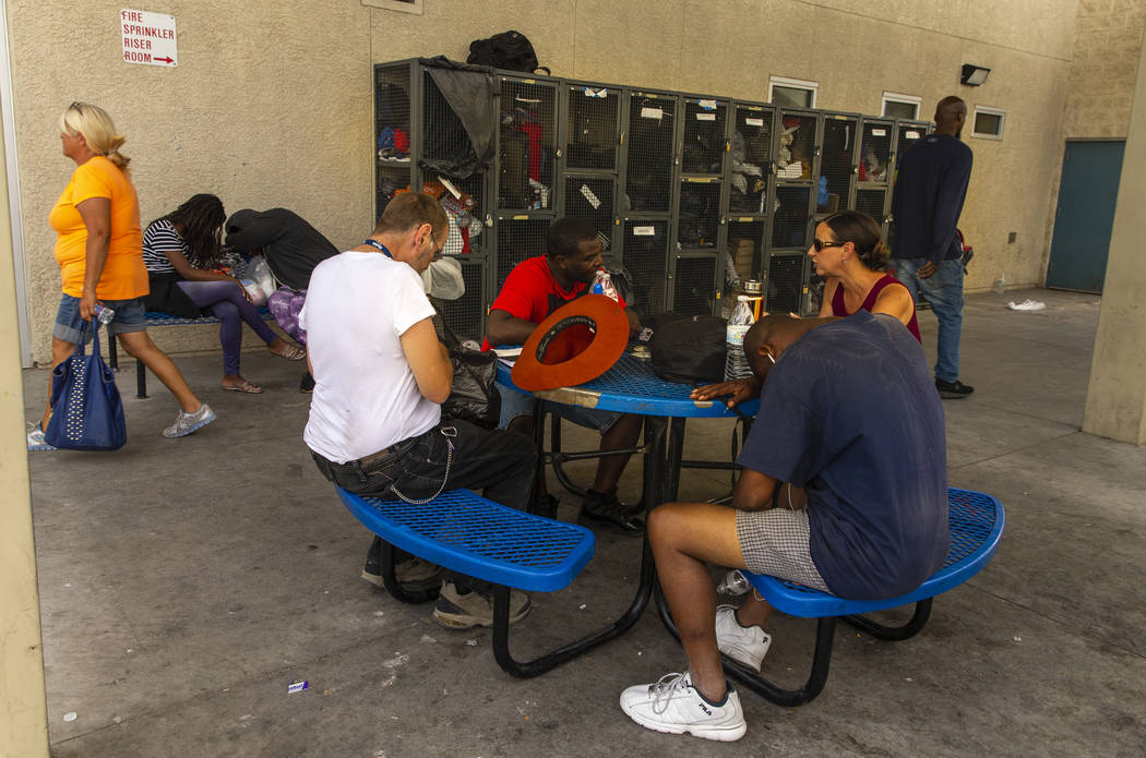 Clients and workers use the courtyard at The Salvation Army, which offers a summer day shelter ...