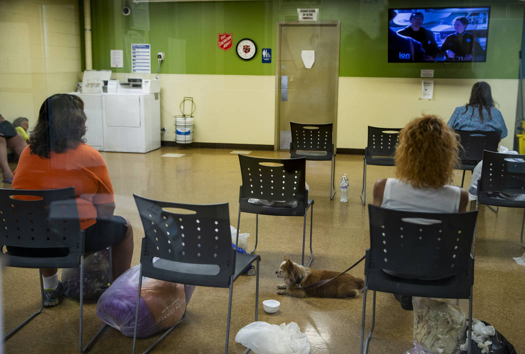 Clients relax in the day room and wash clothes at The Salvation Army, which offers a summer day ...
