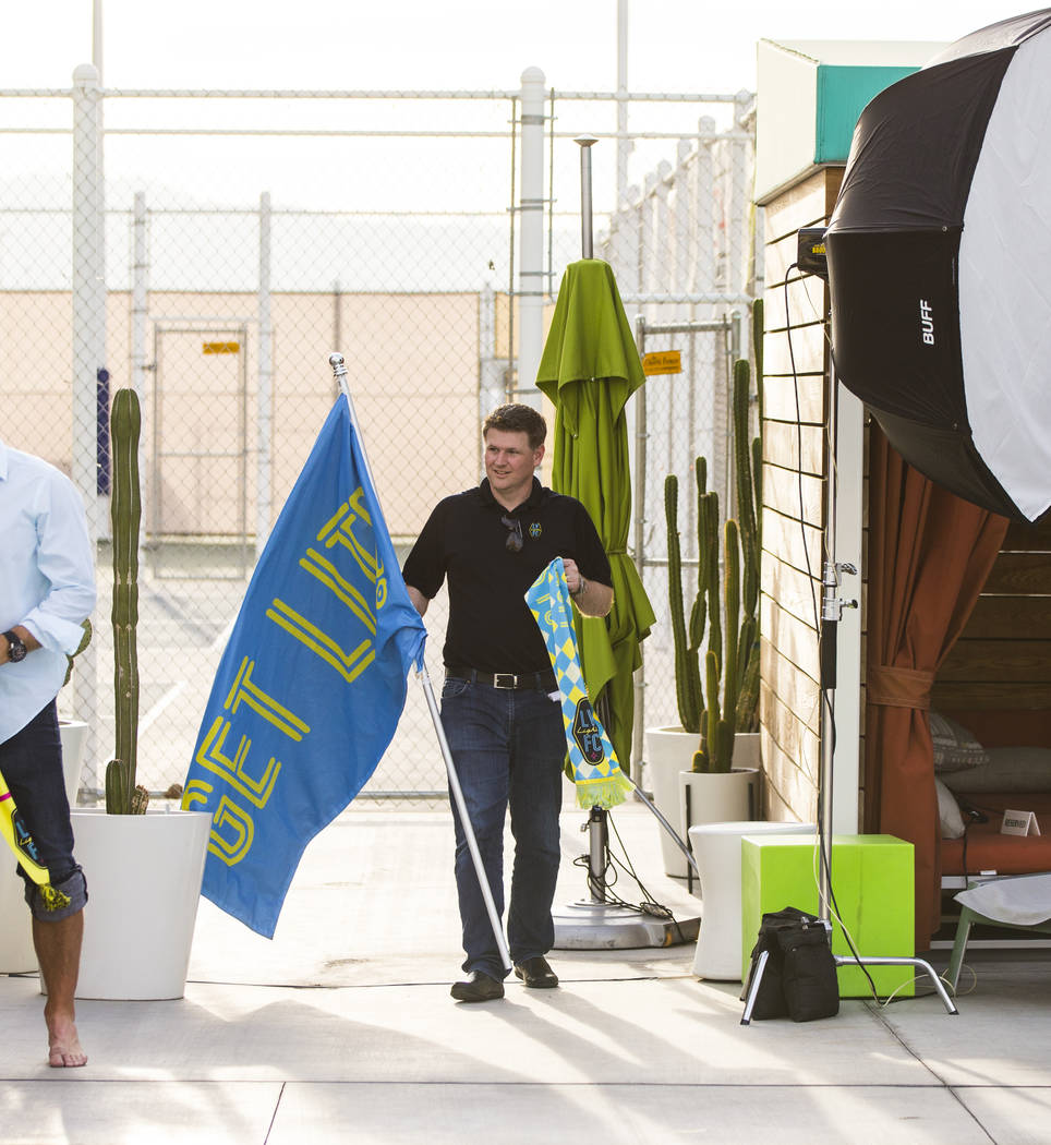 Brett Lashbrook, owner and CEO of Lights FC, walks with props while preparing for his team's ph ...
