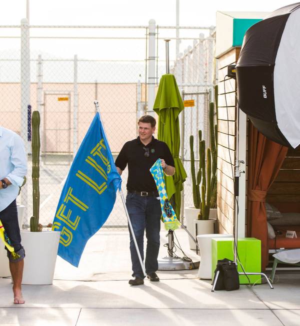 Brett Lashbrook, owner and CEO of Lights FC, walks with props while preparing for his team's ph ...