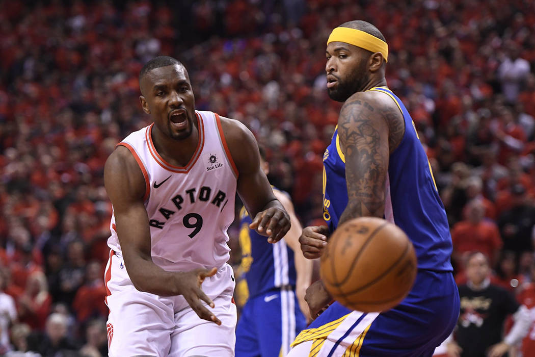 Golden State Warriors center DeMarcus Cousins (0) drives to the net past Toronto Raptors center ...