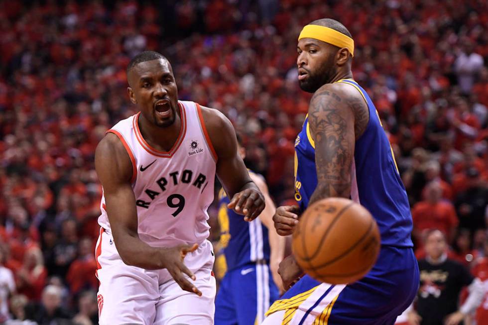 Golden State Warriors center DeMarcus Cousins (0) drives to the net past Toronto Raptors center ...