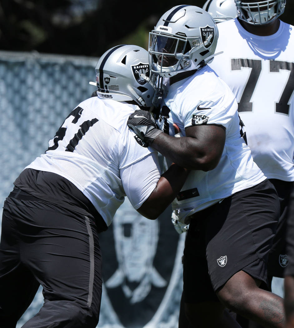 Oakland Raiders center Rodney Hudson (61) shoves offensive tackle David Sharpe (72) during a ma ...