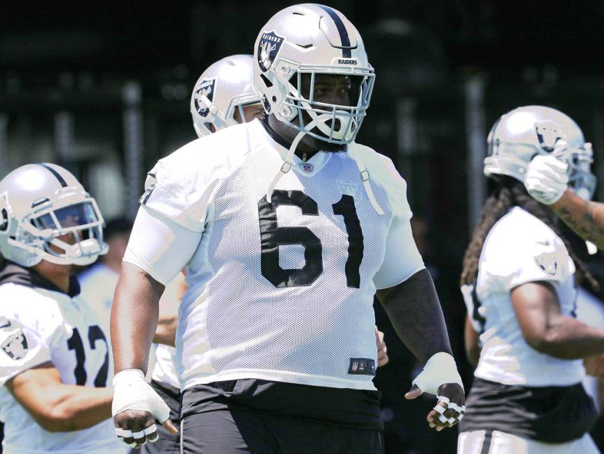 Oakland Raiders center Rodney Hudson (61) warms up during a mandatory mini-camp workout at the ...