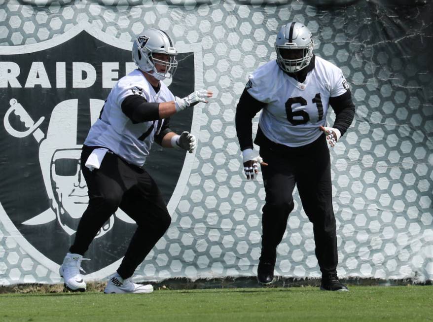 Oakland Raiders offensive guard Jordan Devey (70) and center Rodney Hudson (61) run through a d ...