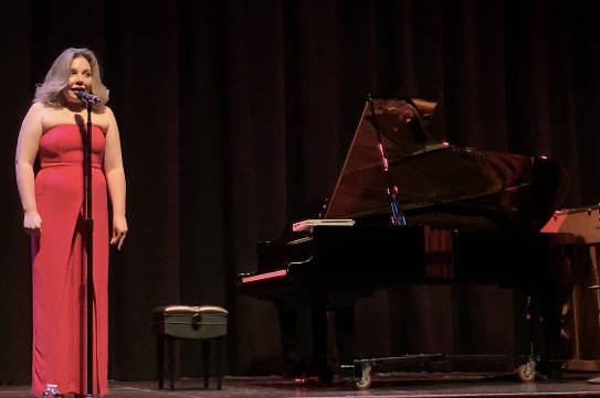 Maria “Masha” Pisarenko introduces one of the acts in the "From Russia with Love" concert a ...