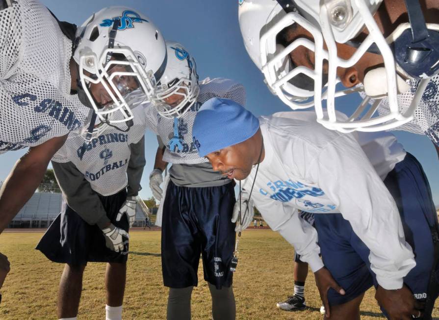 Canyon Springs High School head football coach Hernandez "Hunkie" Cooper, in blue cap, gives hi ...