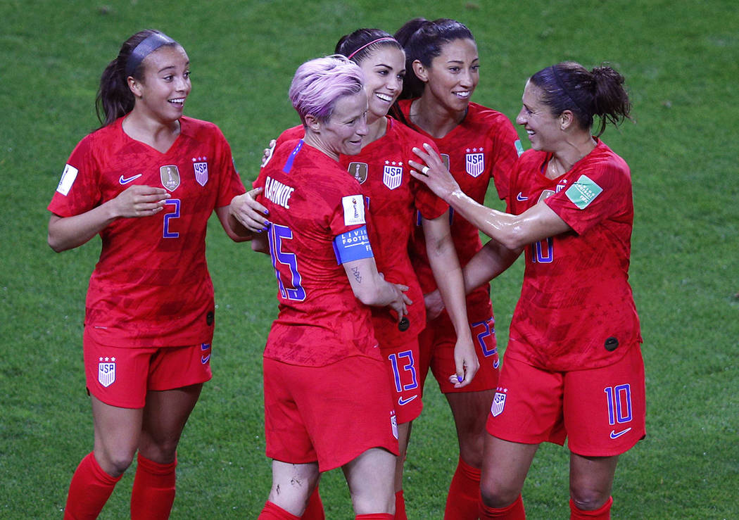 United States' Alex Morgan, centre, is congratulated by teammates after scoring her fifth goal ...