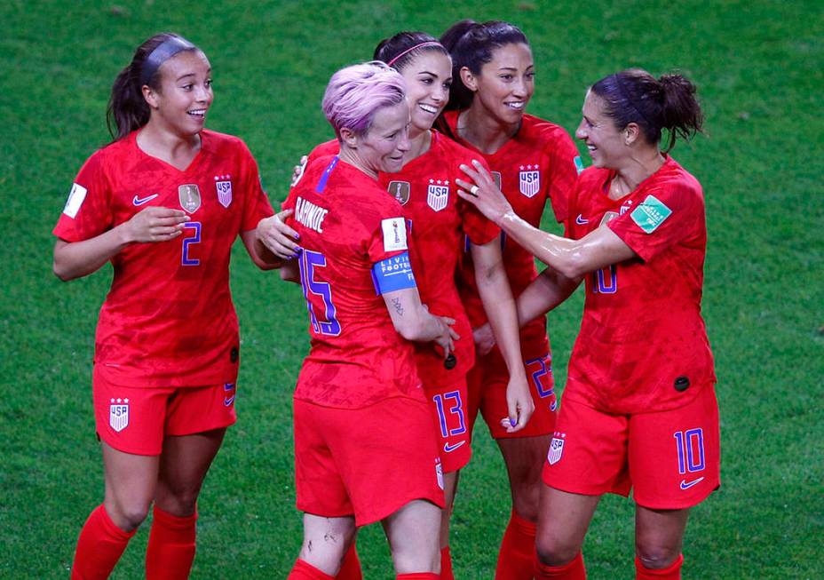 United States' Alex Morgan, centre, is congratulated by teammates after scoring her fifth goal ...
