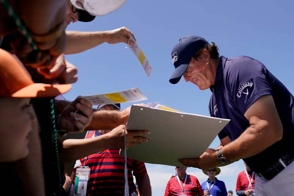 Phil Mickelson signs autographs after a practice round for the U.S. Open Championship golf tour ...