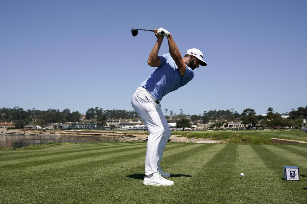 Dustin Johnson hits his tee shot on the 18th hole during a practice round for the U.S. Open Cha ...