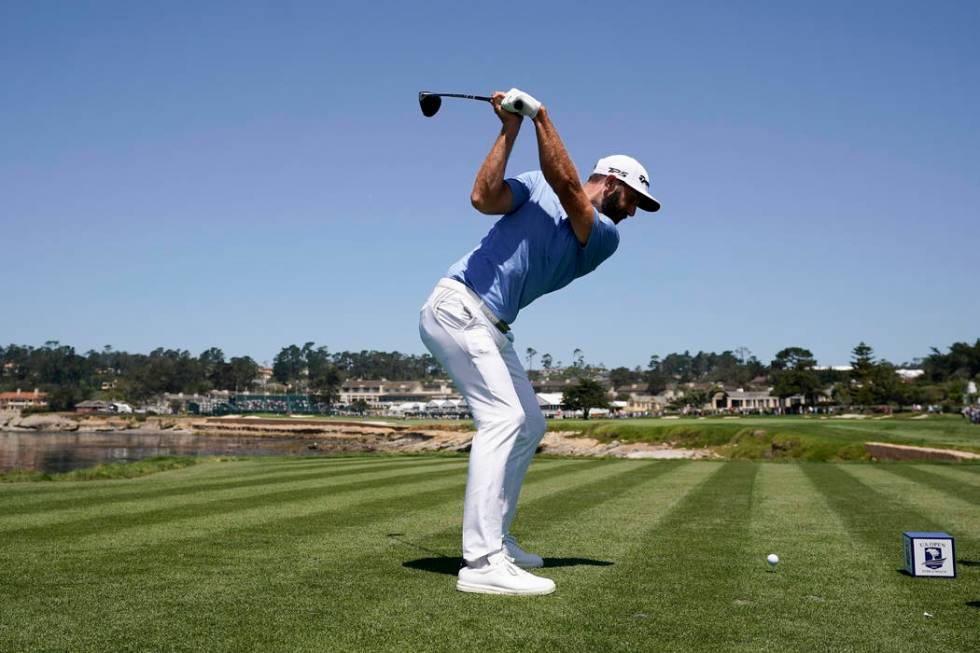 Dustin Johnson hits his tee shot on the 18th hole during a practice round for the U.S. Open Cha ...