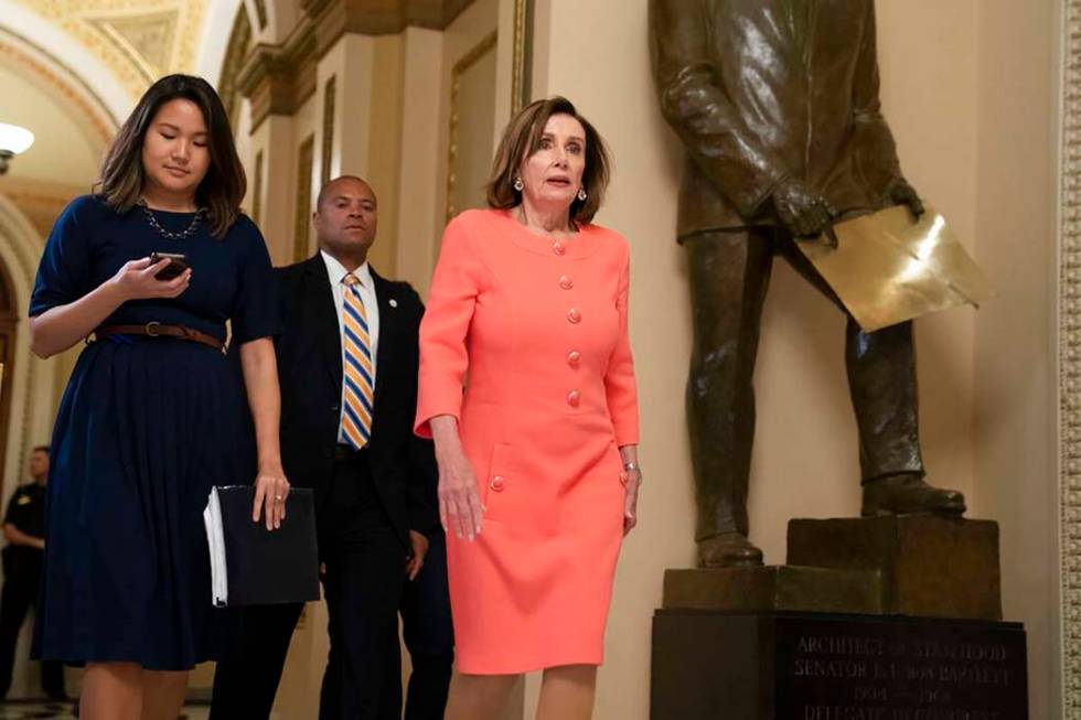 Speaker of the House Nancy Pelosi, D-Calif., walks to her office before voting on a resolution ...