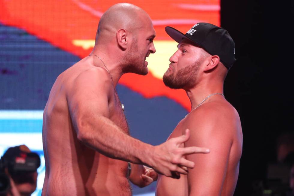 Tyson Fury, left, and Tom Schwarz, pose during their weigh-in event at the MGM Grand Garden Are ...