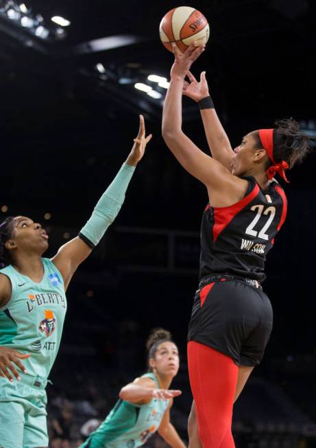 Las Vegas Aces center A'ja Wilson (22) shoots a corner jump shot over New York Liberty forward ...