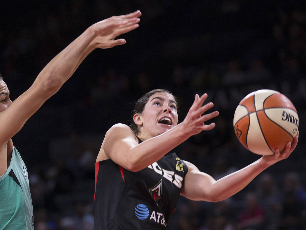 Las Vegas Aces guard Kelsey Plum (10) slices to the rim past New York Liberty guard Kia Nurse ( ...