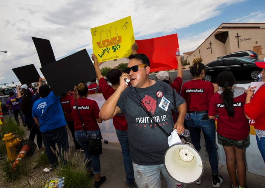 Jose Macias speaks while protesting in support of higher minimum wage outside of McDonald's in ...